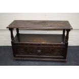 An early 20th century oak monks bench, the lozenge carved fold down top above a box base with carved