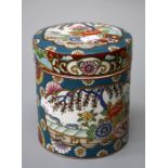 An early 20th Century Chinese cylindrical pot and cover, decoratedwith peonies, lotus and blossoming
