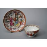 A Chinese famille rose tea bowl and saucer, Qianlong. Decorated with figures in an interior within a