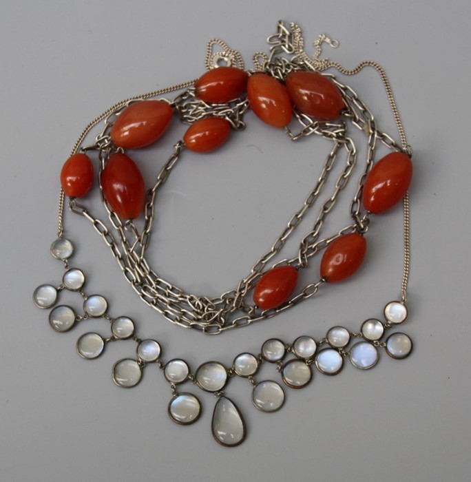 A sterling silver moonstone necklace together with a white metal link necklace and carnelian beads