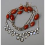 A sterling silver moonstone necklace together with a white metal link necklace and carnelian beads