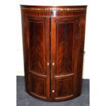 A Geo III satinwood strung mahogany, two door cylinder hanging corner cupboard. 80cm wide