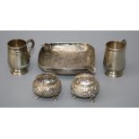 An Indian silver ashtray, two miniature silver tankards and a pair of florally cast bun form salts