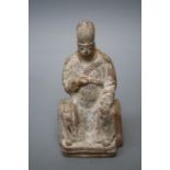 A Chinese Ming style terracotta figure of a seated official with sceptre held to his breast. Signs