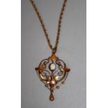 An Edwardian opal set negligee pendant, the central oval opal within pierced scrolling mount to a