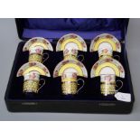 A presentation cased set of six Crescent China coffee cans and saucers with pierced silver frames by