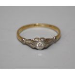 A single stone diamond ring, the brilliant cut diamond in heart shaped mount, to engraved shoulders,