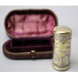 A Victorian silver gilt scent bottle in fitted case, cylindrical with hinged cover, the body