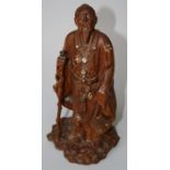 A 19th century Chinese cherrywood figure of Laojun with his attendant sacred crane and rootwood