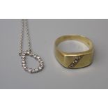 A gentleman's 9ct gold three stone diamond set ring, and a daimond set poear-shaped hoop pendant