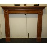A Regency style chimney piece with roundels and moulded decoration. 135cm wide