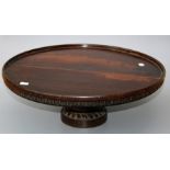 A Victorian mahogany lazy susan, the revolving circular dished top with stop fluted freize, on