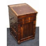 An early 19th century figured rosewood, pedestal Davenport with sliding top and drawers below. 50.