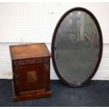 An early 20th century stained pine single door cupboard together with an Edwardian oval wall