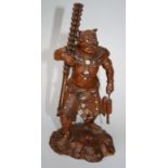 A late 19th century Chinese carved cherrywood figure of a Japanese Oni with inlaid Mother of Pearl