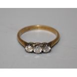A three stone diamond half hoop ring, the old brilliant cut diamonds in eight claw mounts to plain