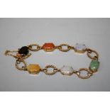 A multi gem set 9ct gold bracelet composed of claw set semi precious stones with rope twist spacers,