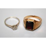 A single stone garnet ring, the rectangular cut-cornered garnet in stepped rub over mount to