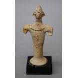 A Syro-Hittite style clay figure of hawk like anthropomorphic form with old repair to body. This