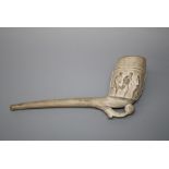 A circa 1880's clay pipe of generous proportions, the bowl decorated in shallow relief with
