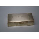 S Ltd., a silver cigarette box with engine turned hinged cover initialled S.B enclosing a cedar