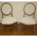 A pair of 19th century French cream and parcel gilt cameo back side chairs with channelled outline a