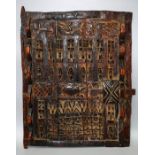 An West African carved hardwood  grain store door with stylised animals and geometric Benin style