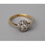 An Edwardian diamond cluster ring, the nine stone brilliant and old brilliant cut cluster in
