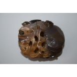A Chinese carve and pierced agate pebble decorated with a large peach and a cicada. 5.5cm long
