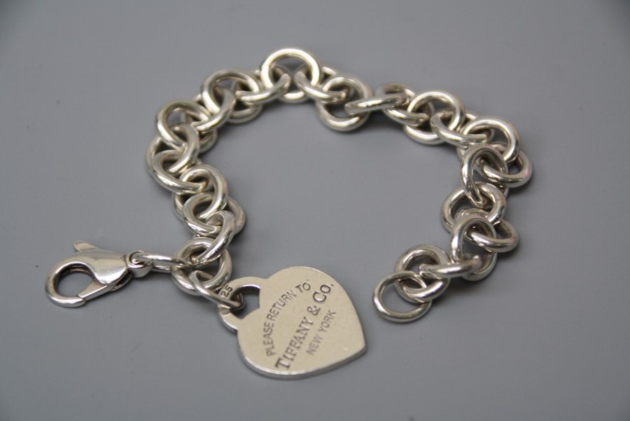 A modern Tiffany and Co bracelet with heart -shaped tag engraved 'please return to Tiffany & Co. New