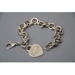 A modern Tiffany and Co bracelet with heart -shaped tag engraved 'please return to Tiffany & Co. New
