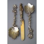 A pair of Victorian cast silver fruit serving spoons, formed as fruiting vines with vine leaf bowls,