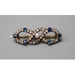 A late Victorian sapphire, diamond and pearl open bow brooch, the diamond set bow with applied