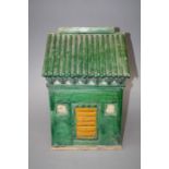 A Chinese pottery tomb type model of a house with sancai glaze. modelled with central door and tiled