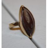 An African engraved husk ring navette shaped in surround mount to plain band. 4.7g gross weight