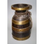 A Tibetan,probably 19th century chang (Beer) pot and cover with brass banding and rope handle.