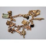 A 9ct gold charm bracelet, the reeded rose gold belcher chain suspending numerous charms, watch keys