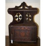A small late 19th century pokerwork hanging corner cupboard, the pierced superstructure, over a
