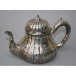 Garrard. A Victorian silver bachelors teapot of low bellied panelled form, with domed, hinged