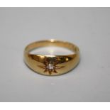 An 18ct gold single stone gypsy set diamond ring to a tapered band. Size P, 3.1g