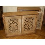 Two early 20th century limed oak two door cupboards with neo-classical pierced panels. 105cm wide