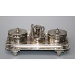 A two bottle table inkstand with central taperstick and pounce pot, rounded rectangular with