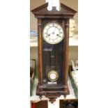 A late 19th Century Vienna wall clock, mahogany cased, the single door set with turned columns