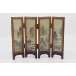 A Chinese four-fold miniature screen, probably Republic period, the hardwood frame enclosing silk