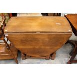 A Jacobean style oak gateleg table, two leaves and raised on turned legs, 76cm high, 90cm wide, 43cm