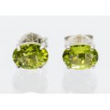 A pair of peridot and silver studs, oval faceted peridots set in four claw mounts, size approx 7mm x