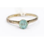 A blue zircon and 9ct white gold ring, compromising a round cut zircon claw set to a narrow band,