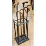 An oak early to mid 20th Century coat stand along with mid 20th Century cast iron stick stand with