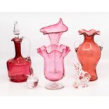 A Victorian cranberry glass claret jug, a twin handled vase with flared rim, a trumpet shaped