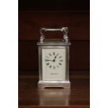 A Mappin & Webb silver plated carriage clock, white dial and black Roman numerals, 13 cms high